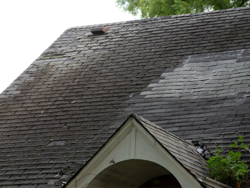 Aerial view of roof surface showing the top section of shingles, illustrating how roof damage affects your home’s value.