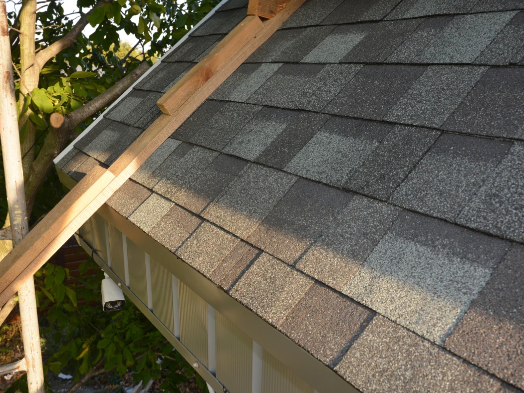 Eco-Friendly Roofing for Spring - WorleyByrd image of a residential roof with gray shingles in sunlight